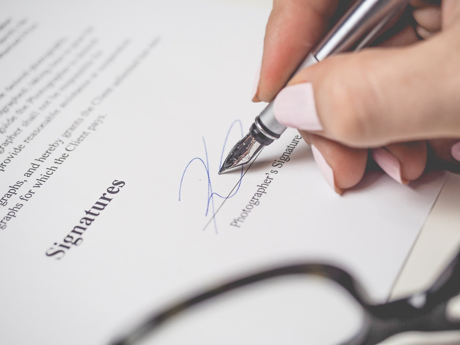 Iemand ondertekent een document met een vulpen